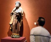 Un visitante contempla una talla de San Pedro, obra de Alejo de Bahía, en Las Edades del Hombre de Ávila. / J. G.