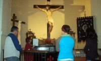 Varios turistas contemplan el Cristo de la Agonía en la parroquia de Santiago el Real. / FRAN JIMÉNEZ